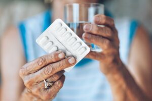 Senior woman taking her daily medication